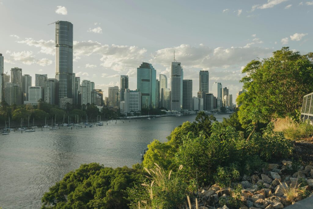 Stunning view of Brisbane's modern skyline and lush greenery by the river.